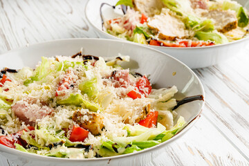 Caesar salad on a white wooden rustic background