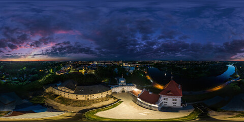 aerial seamless spherical 360 night panorama overlooking old town, historic buildings and medieval castle at sunset in equirectangular projection