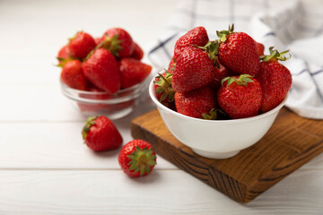 Fresh ripe strawberries in a plate on a white wooden background.Vegetarian organic berry.Healthy food.Vitamins.Copy space.Space for text