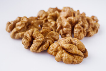 dried walnuts on a white acrylic background