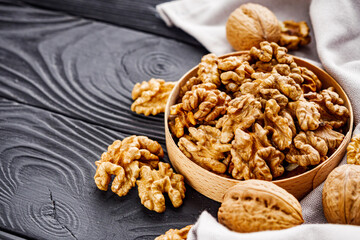dried walnuts on a black rustic wooden background