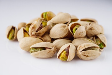 fresh salted pistachios on a white background