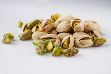 fresh salted pistachios on a white background