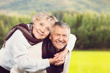 Fototapeta premium Perfect happy senior couple going for a walk in the park.