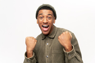 Excited overjoyed man shouting making yes gesture, amazed with his victory, triumph. Indoor studio...