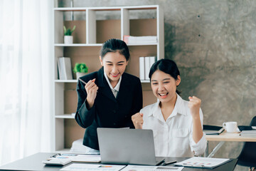 Asian businesswoman in formal suit in office happy and cheerful during using smartphone and working