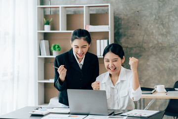 Asian businesswoman in formal suit in office happy and cheerful during using smartphone and working