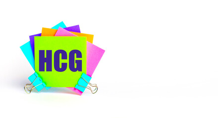 There are bright multi-colored stickers with the text HCG Human Chorionic Gonadotrophin. Copy space