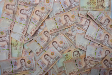 Close-up a pile of one thousand Thai Baht (THB) banknotes of Thailand. Cash of thousand baht bills, Background image with high resolution.