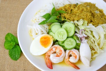 Food rice noodles with crab curry sauce on white dish on white background.