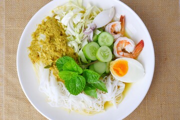 Food rice noodles with crab curry sauce on white dish on white background.