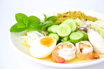 Food rice noodles with crab curry sauce on white dish on white background.