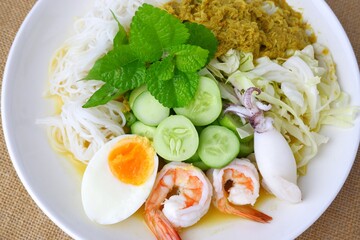 Food rice noodles with crab curry sauce on white dish on white background.