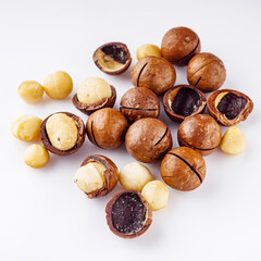 fresh macadamia nuts on a white acrylic background