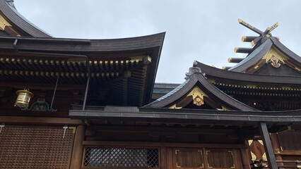 Fototapeta na wymiar The main pagoda of Yushima Tenjin, the historic establishment in 458 the beautiful architecture with plum symbolic family crest “Kamon”. Photo taken year 2022 June 15th