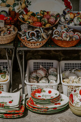 Local market and souvenirs in a town of Ravello, Amalfi Coast, Italy. Handmade ceramic goods, stalls, street on a sunny day 