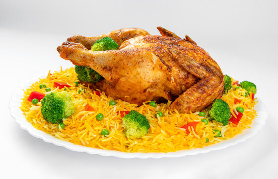 Full Chargha (Whole Grilled Chicken) with Vegetables and Saffron Rice. Extremely Delicious and Spicy Food. This food also called Mandee in Arab Countries.