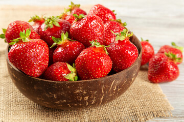 Strawberry in a brown coconut plate
