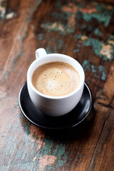  Cup of coffee on wooden background. Close up.