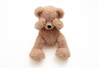 Child abuse concept. Teddy bear cover eye isolated on white background