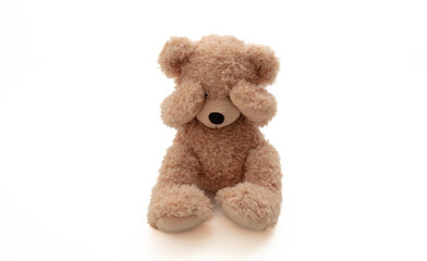 Child abuse concept. Teddy bear cover eye isolated on white background