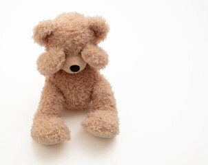 Child abuse concept. Teddy bear cover eye isolated on white background