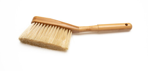 Brush with wooden handle isolated on white background. Domestic broom for sweep and clean