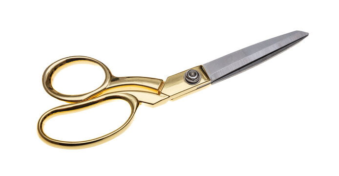 Pair of scissors with golden handle isolated cutout on white background