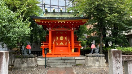 Vivid vibrant pagoda house of Japanese shrine “Kandamyojin”, tiny house in the back ally with fox guardians (messenger of God) enshrined in pairs.  Old Shinto family established in 730.  2022/6/15
