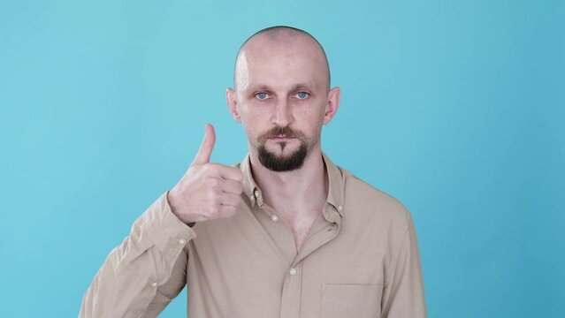 Well done. Like sign. Boomerang motion. Offer approval. Confident sarcastic man supporting with thumb up deal gesture gif loop isolated on blue empty space background.