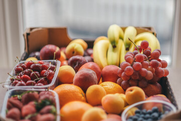 Various fruits in a cardboard box. Shopping for the week. Summer harvest. Diverse food. Healthy food. Farm organic products, fresh harvest and nutrition concept.