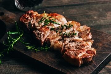 Grilled pork steak on a wooden board