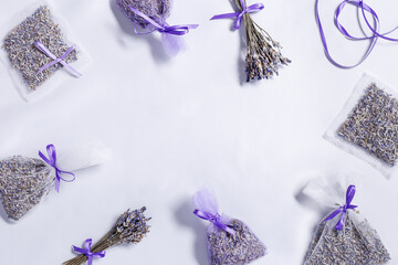 Making DIY lavender sachets for home, for gifts, natural scented bags from organza on white lavender colored silk cloth. Aromatherapy for for relaxation and good sleep