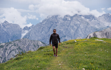 Naklejka na ściany i meble Male hiker in the Italian Dolomites Mountains 