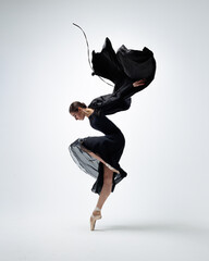 Elegant ballerina. A young graceful ballet dancer, dressed in pointes shoes demonstrates her dance...
