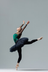 Elegant ballerina. A young graceful ballet dancer, dressed in pointes shoes demonstrates her dance...