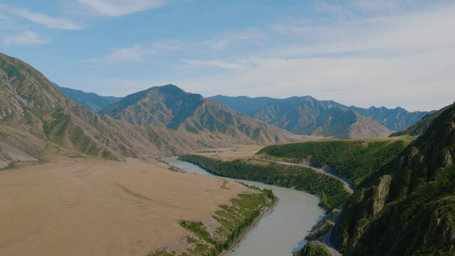 Mountains valley of Altai with blue Katun river and Chuya highway, Siberia, Russia. Beautiful summer nature landscape at during daytime. Aerial view from a drone