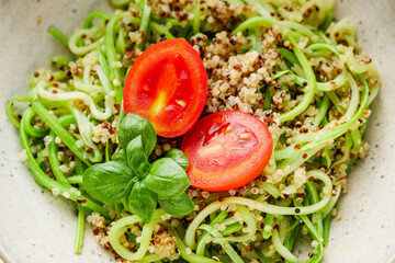 zucchini noodles with quinoa on a white background