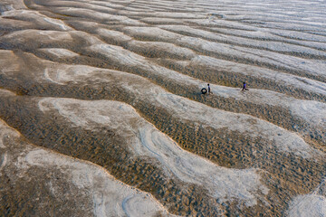 Huge sandbars arise in river Jamuna when the water level drops during the dry season. The striking pattern and textures look like desert when seen from above. Aerial sandbar view. Beauty of Nature.