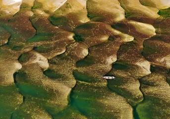 Huge sandbars arise in river Jamuna when the water level drops during the dry season. The striking pattern and textures look like desert when seen from above. Aerial sandbar view. Beauty of Nature.