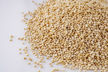 white quinoa seeds on a white acrylic background