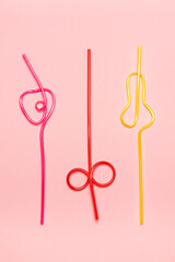 Cocktail straws Day. Drinking straws on a pink background. Summer cocktail party.