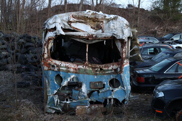 old decaying and eroded bus in the junkyard