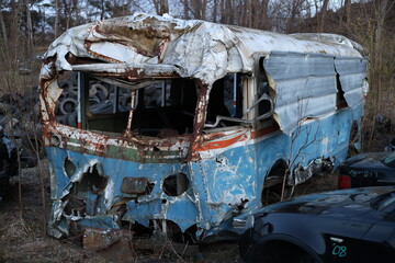 old decaying and eroded bus in the junkyard