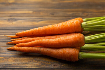 Fresh carrots on brown texture background. Ingredient for salad.Vegetarian organic vegetables.Healthy food.Copy space.Place for text