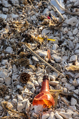 Plastic bottles and waste washed up on a beach by the incoming tide, covering the entire beach 