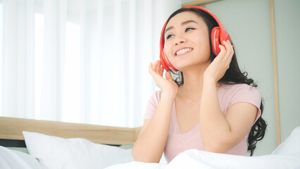 Naklejka premium Portrait of woman listening song and enjoyment expression in bedroom at home.