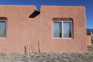 pueblo style home exterior with windows