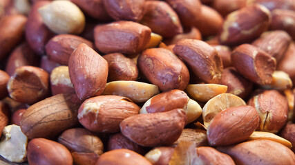 Roasted unpeeled peanuts close-up. Close-up on peanuts background