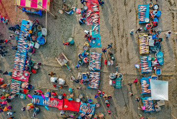 Aerial view of traditional village fair in Bangladesh. Colorful tents of temporary shops make it look like blocks of tetris game.  Portable ferris wheel